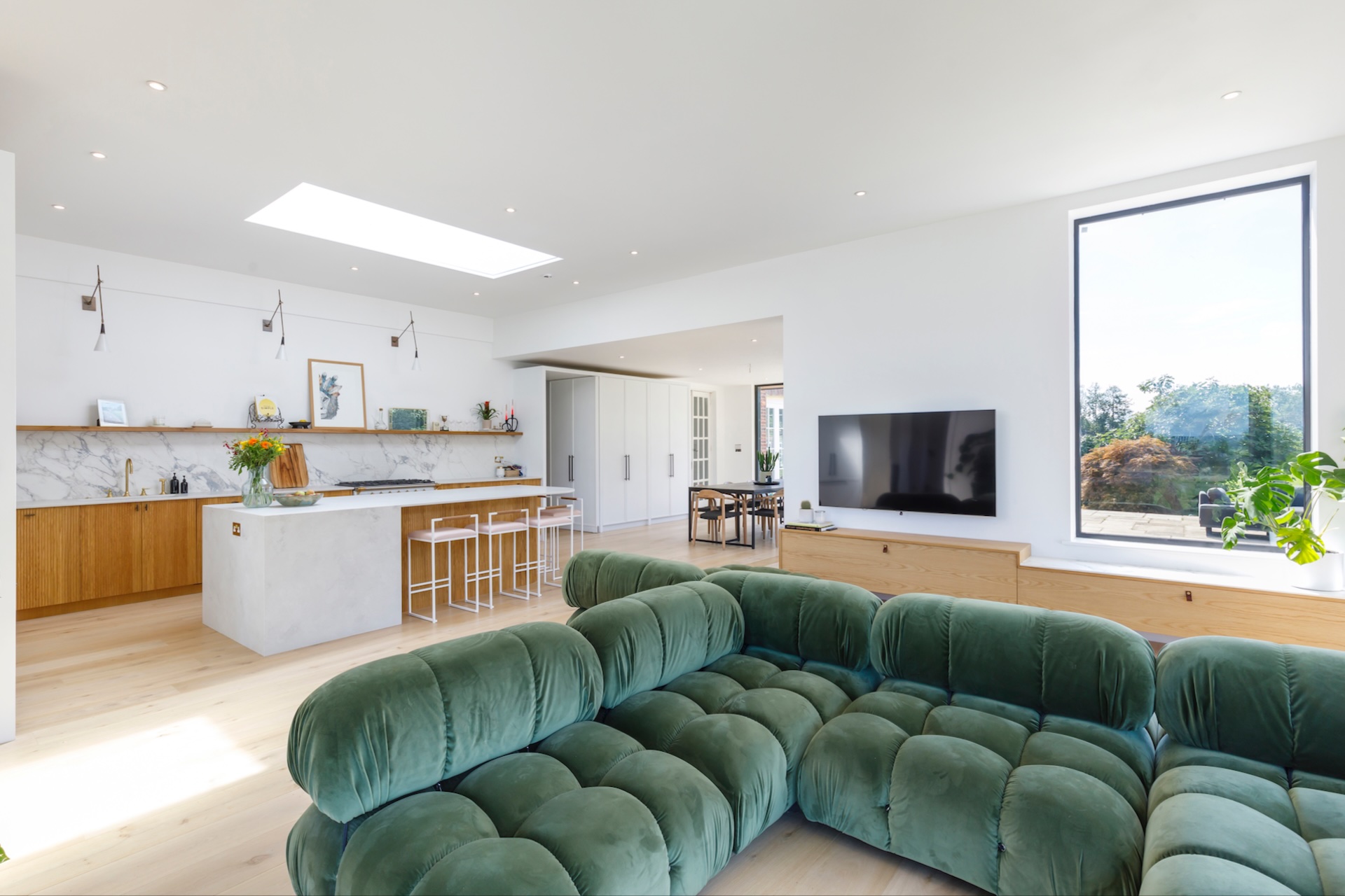 Contemporary living room with green velvet seating