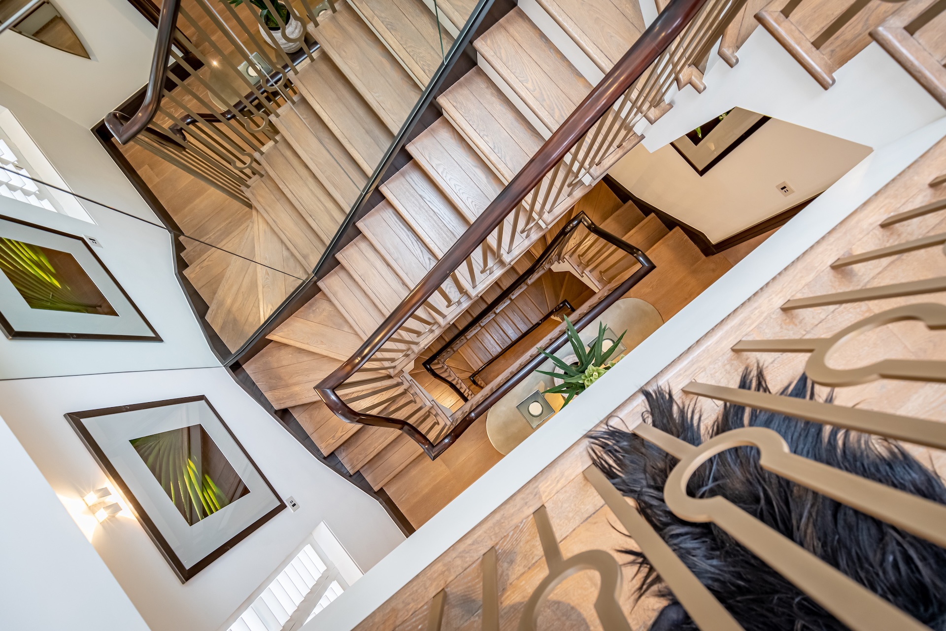 Architectural staircase with timber railings and framed artwork